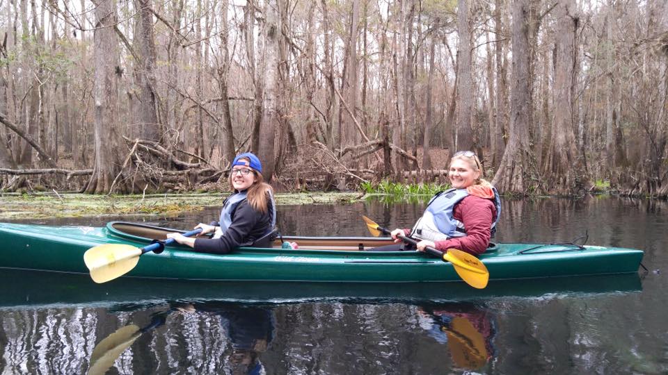 UF graduate students Meghan Mangrum, left, and Hannah O. Brown paddle North Florida's Ichetucknee River on a field trip for Environmental Journalism class.